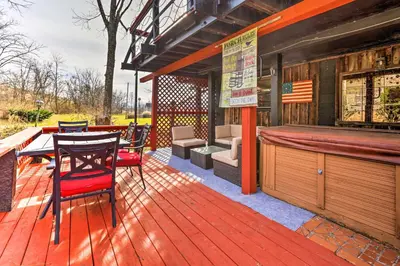 a wooden deck with a bar and a table and chairs at Peaceful Mt Sterling Cabin Deck and Fire Pit! in Mount Sterling