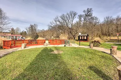 a park with a grassy area with an orange fence at Peaceful Mt Sterling Cabin Deck and Fire Pit! in Mount Sterling