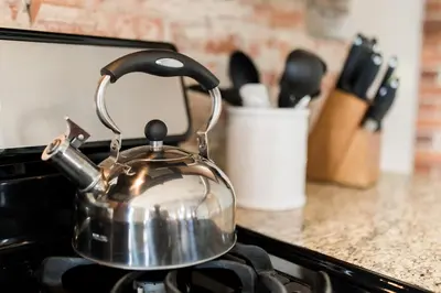 a tea kettle sitting on top of a stove at The Penthouse- Heart of OTR w/Rooftop Terrace in Cincinnati