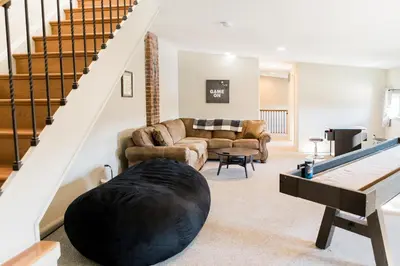 a living room with a large black ball on the floor at The Penthouse- Heart of OTR w/Rooftop Terrace in Cincinnati