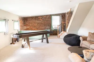 a living room with a piano and a couch at The Penthouse- Heart of OTR w/Rooftop Terrace in Cincinnati