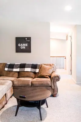 a living room with a couch and a table at The Penthouse- Heart of OTR w/Rooftop Terrace in Cincinnati