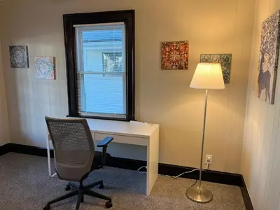 an office with a desk and a chair and a lamp at Hunter #1, Private One Bed near Xavier & Downtown in Bellevue