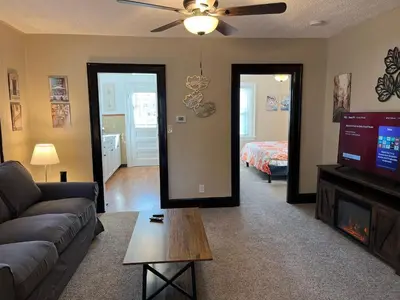 a living room with a couch and a tv and a bed at Hunter #1, Private One Bed near Xavier & Downtown in Bellevue