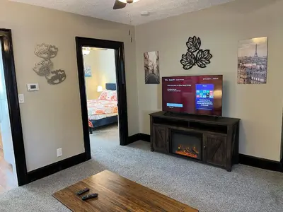 a living room with a tv and a fireplace at Hunter #1, Private One Bed near Xavier & Downtown in Bellevue