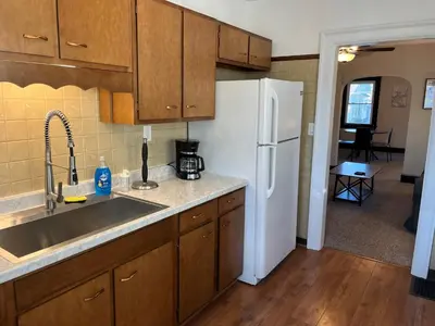 a kitchen with a sink and a white refrigerator at Hunter #1, Private One Bed near Xavier & Downtown in Bellevue