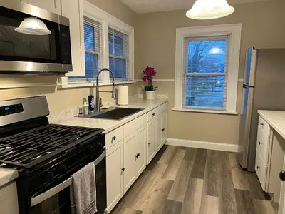 a kitchen with a sink and a stove top oven at Hunter #2 Private One Bed near Xavier & Downtown in Bellevue