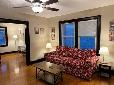 a living room with a red couch and a table at Hunter #2 Private One Bed near Xavier & Downtown in Bellevue