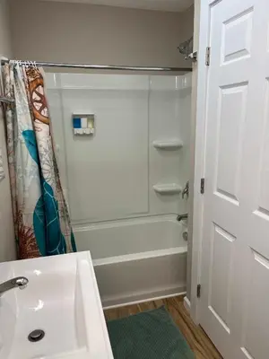 a bathroom with a shower and a white sink at Wilson Two Bedroom House in Historic Loveland in Loveland