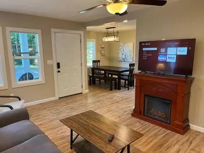 a living room with a fireplace and a tv at Wilson Two Bedroom House in Historic Loveland in Loveland