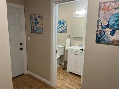 a bathroom with a sink and a toilet and a mirror at Wilson Two Bedroom House in Historic Loveland in Loveland