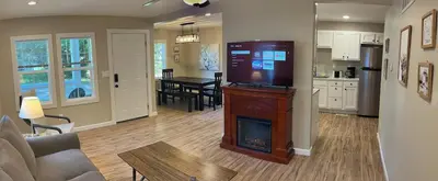 a living room with a fireplace and a kitchen at Wilson Two Bedroom House in Historic Loveland in Loveland