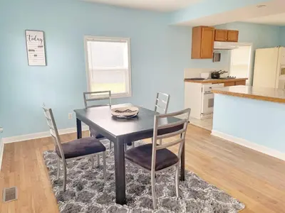 a dining room with a table and chairs in a kitchen at Housepitality - The Bliss Lodge - Large House in Columbus