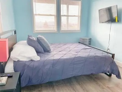 a bedroom with a bed with purple sheets and pillows at Housepitality - The Bliss Lodge - Large House in Columbus