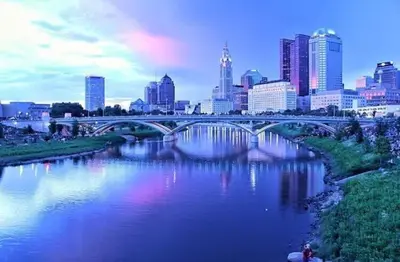 a bridge over a river with a city in the background at Housepitality - The Bliss Lodge - Large House in Columbus