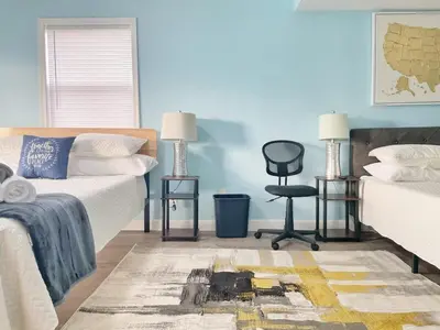 a bedroom with a bed and a desk and a chair at Housepitality - The Bliss Lodge - Large House in Columbus