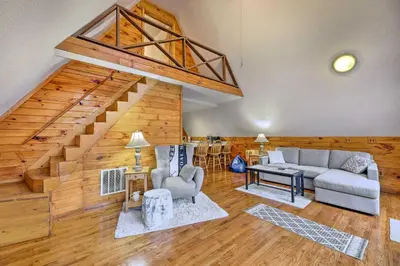 a living room with a couch and a table at Cozy Yatesville Lake Cabin Rental in Louisa! in Louisa
