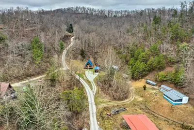 an aerial view of a winding road in a forest at Cozy Yatesville Lake Cabin Rental in Louisa! in Louisa