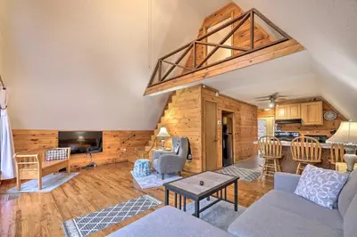 a living room with a couch and a table at Cozy Yatesville Lake Cabin Rental in Louisa! in Louisa