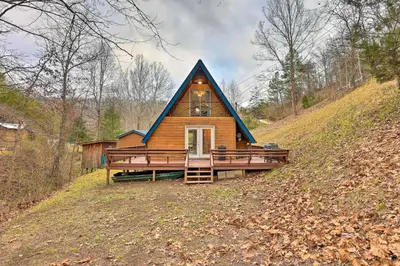a house with a gambrel roof on a hill at Cozy Yatesville Lake Cabin Rental in Louisa! in Louisa