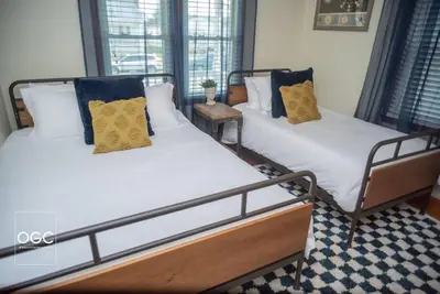 two twin beds in a room with at WV Bohemian Bungalow in Kenova