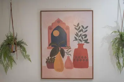 a picture of vases and plants on a wall at WV Bohemian Bungalow in Kenova