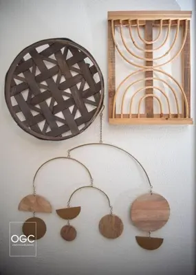 a group of wooden items hanging on a wall at WV Bohemian Bungalow in Kenova