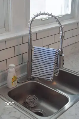 a kitchen sink with a towel hanging over the sink at WV Bohemian Bungalow in Kenova