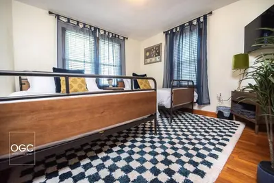 a bedroom with a bed and a rug at WV Bohemian Bungalow in Kenova