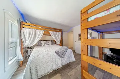 a bedroom with a bed with a wooden frame at Cottage in the Falls, 2 b, 2 bath, fireplace in Cuyahoga Falls
