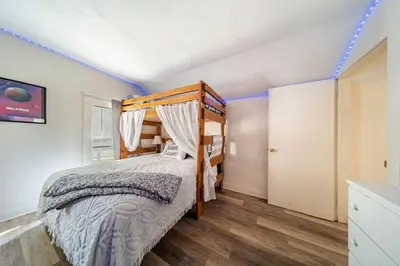 a bedroom with a bed with a wooden bed frame at Cottage in the Falls, 2 b, 2 bath, fireplace in Cuyahoga Falls
