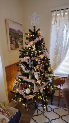 a christmas tree is in a living room at Cottage in the Falls, 2 b, 2 bath, fireplace in Cuyahoga Falls