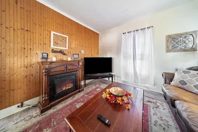 a living room with a couch and a fireplace at Cottage in the Falls, 2 b, 2 bath, fireplace in Cuyahoga Falls