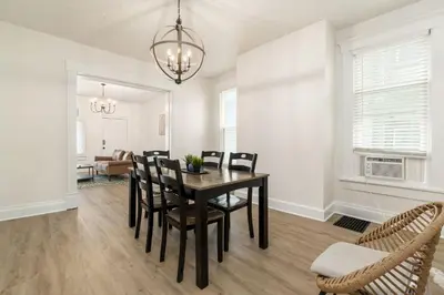a dining room with a black table and chairs at Housepitality - The Madison House - Brand New in Columbus