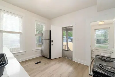 an empty kitchen with a stainless steel refrigerator at Housepitality - The Madison House - Brand New in Columbus