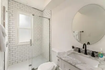 a white bathroom with a sink and a mirror at Housepitality - The Madison House - Brand New in Columbus