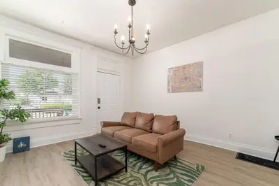 a living room with a couch and a table at Housepitality - The Madison House - Brand New in Columbus