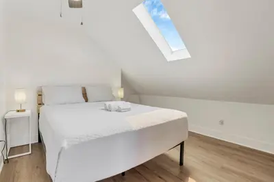 a white bedroom with a bed and a window at Updated 4BD House Near German Village w Parking in Columbus