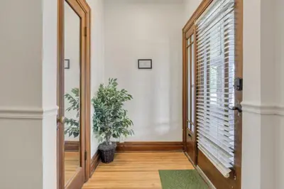 a hallway with a mirror and a potted plant at Updated 4BD House Near German Village w Parking in Columbus