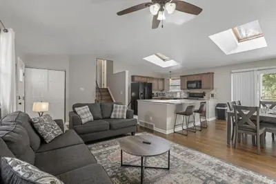 a living room and kitchen with a couch and a table at Housepitality - The Woodward Park Charmer - 4BR in Columbus