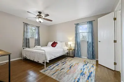 a bedroom with a bed and a ceiling fan at Housepitality - The Woodward Park Charmer - 4BR in Columbus