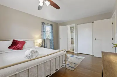 a bedroom with a bed and a ceiling fan at Housepitality - The Woodward Park Charmer - 4BR in Columbus