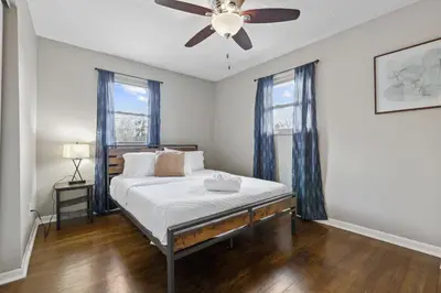 a bedroom with a bed with a ceiling fan at Housepitality - The Woodward Park Charmer - 4BR in Columbus