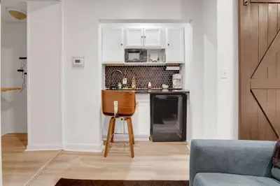a kitchen with a counter and a chair in a room at Housepitality - The Brandenburg Suite - Efficiency in Columbus