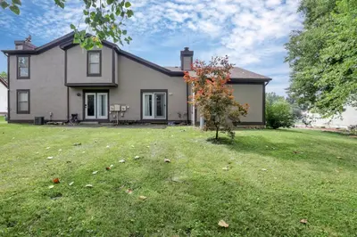 a house with a grass yard in front of it at Housepitality - The Gahanna Hideaway in Gahanna