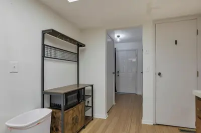 a room with a toilet and a mirror and a door at Housepitality - The Gahanna Hideaway in Gahanna