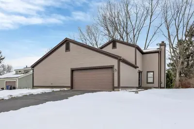 a house with a garage in the snow at Housepitality - The Gahanna Hideaway in Gahanna