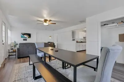 a dining room and living room with a table and chairs at Housepitality - West Side Lodge - 6 BR 2 BA in Columbus
