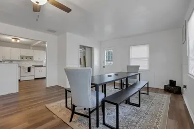 a dining room with a table and chairs and a kitchen at Housepitality - West Side Lodge - 6 BR 2 BA in Columbus