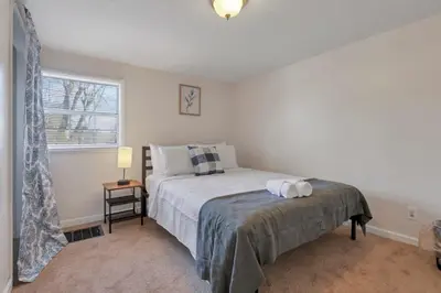 a bedroom with a bed and a window at Housepitality - West Side Lodge - 6 BR 2 BA in Columbus